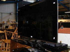 A flat screen Samsung TV, together with a Samsung