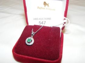 An emerald and diamond pendant in 9ct white gold s