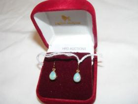 A pair of teardrop shaped opal earrings