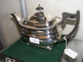 A silver teapot with Sheffield hallmark