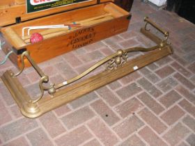 A antique brass fender
