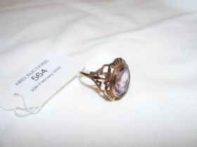 A 9ct amethyst oval dress ring in decorative setti