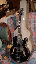 A 'Hagstrom' HJ500 electric guitar with hard carrying case and display stand