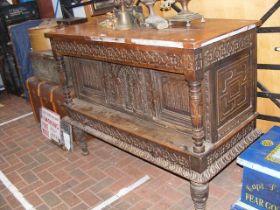 An antique carved oak cupboard - 146cms wide