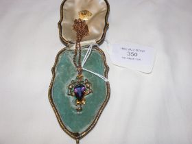 An Edwardian amethyst and seed pearl pendant on ch