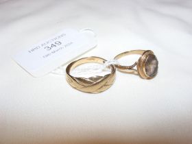A gold dress ring and one other