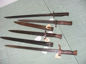 An assortment of four vintage bayonets
