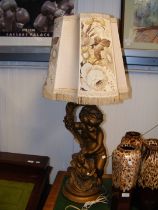 A gilt plaster cherub table lamp
