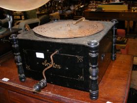 An antique Ariston wind up music box with paper di