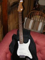 An QTX electric guitar in soft carrying case