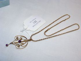 An Edwardian amethyst and seed pearl pendant on ch