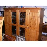 A pine four door wardrobe with acorn carved motif