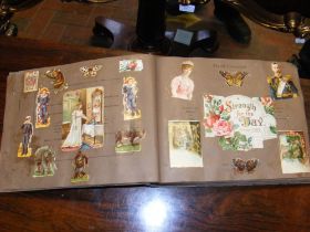 An antique scrapbook containing Victorian card cut