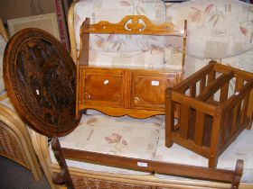 A wooden magazine rack, carved wooden wall plaque