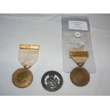 A Red Cross medal, together with two others