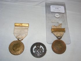 A Red Cross medal, together with two others