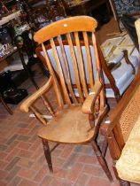 An antique slat back country armchair