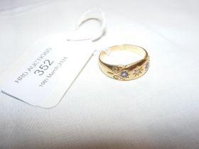 A diamond and pale blue stone ring in 18ct setting