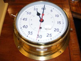 A brass bulkhead maritime wall clock