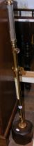 A brass marine barometer - 82cms high on wooden st