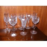 A collection of various Waterford hock glasses and champagne flutes