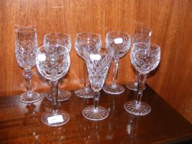 A collection of various Waterford hock glasses and champagne flutes