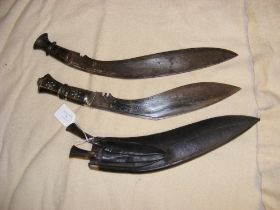 A kukri in leather scabbard, together with another