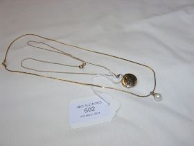 A circular gold locket on chain