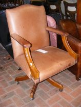 An antique style brown swivel office chair