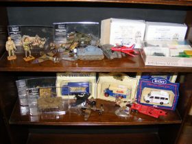 A collection of die cast model vehicles on two she