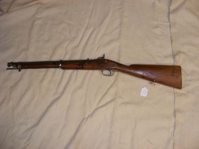 An antique short barrelled percussion rifle with ramrod