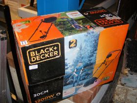 A Black and Decker lawnmower in box