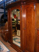 A Victorian mahogany breakfront wardrobe with mirr