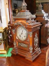 An antique wooden cased mantel clock - 50cms high