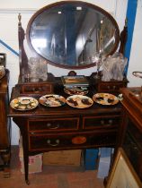 An antique mahogany dressing table with oval swing