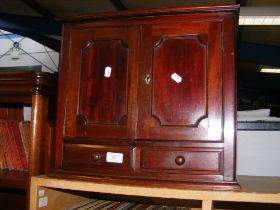 A mahogany miniature cupboard
