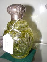 A silver topped scent bottle with overlay cut glas