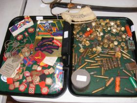 Two trays of militaria, including buttons, shoulder badges