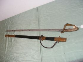 An antique naval sword with decorated brass guard