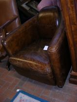 An Art Deco style brown leather easy chair