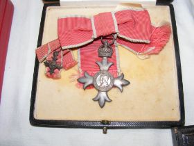 An MBE with miniature in original leather box