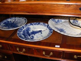 Two Delft style blue and white wall plates together with