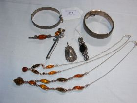 A silver bangle, brooches etc.