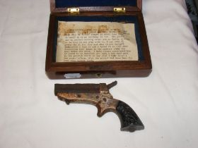 A miniature antique pocket pistol with some histor
