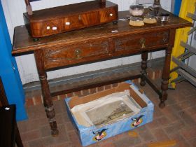 An antique oak side table with two drawers to the