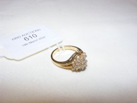 An 18ct ring with diamond mounted swirl design