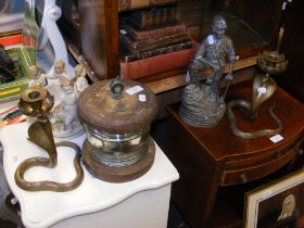 A pair of brass 'cobra' candlesticks, ships lamp, Meissen ceramic cherub bowl etc.