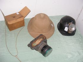 An old pith helmet, leather helmet and old respira