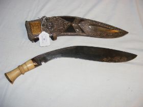 A Middle Eastern kukri with decorative white metal