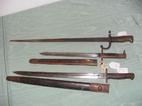 Three assorted bayonets - two with scabbards